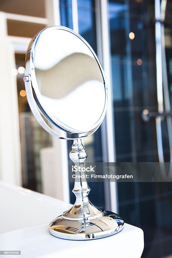 Vanity Mirror In A Bathroom A round, table mirror with chrome articulated arm on a bathroom Mirror - Object Stock Photo