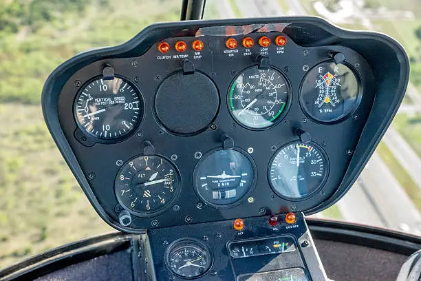 Altimeter, Variometer, and helicopter instrument panel while airborne. Altitude gauge, Vertical Speed Indicator, and instrument panel while airborne in a Robinson R22 small helicopter.