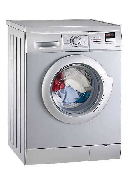 Photo of Washing machine mid-cycle on white background