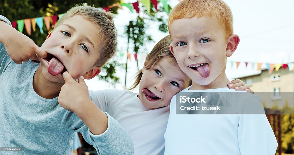 Kids Making a Face Outdoor portrait of three preschool kids making a funny faces. 4-5 Years Stock Photo