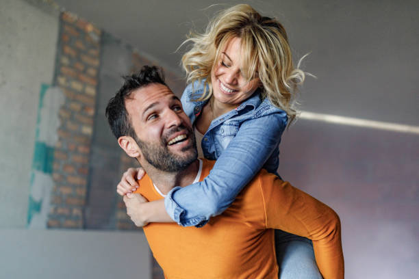 istock Carefree couple having fun while piggybacking at construction site. 1807253356