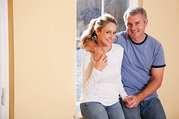 istock Couple sitting on window sill 180725363
