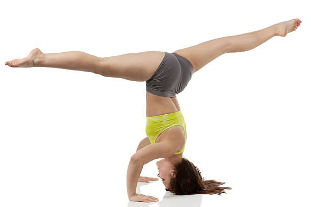 istock Side view of a woman performing headstand 180725393