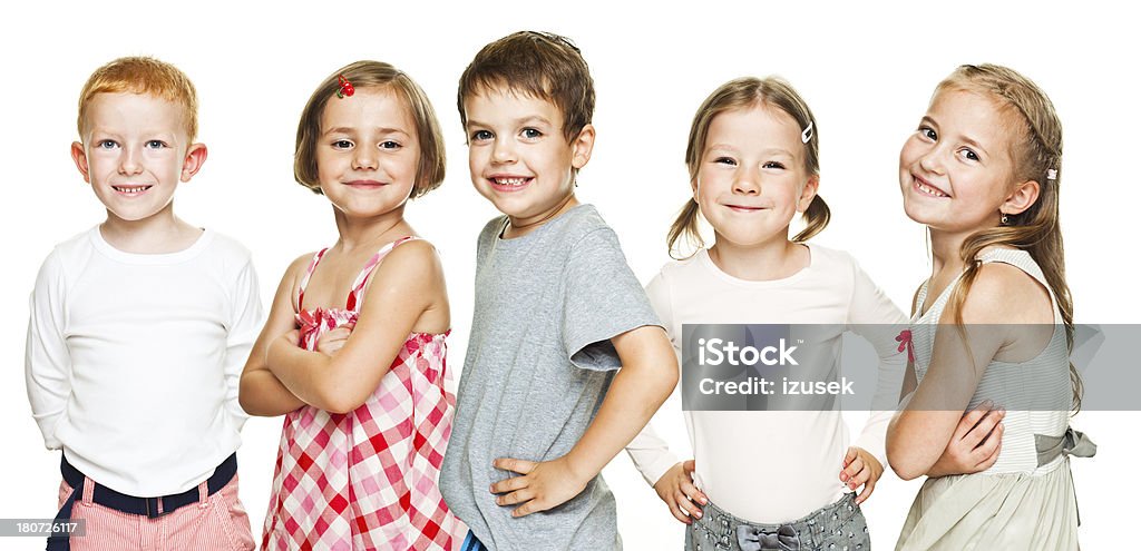 Kids In a Row Five preschool kids standing in a row, smiling at the camera. Studio shot, isolated on white. Child Stock Photo