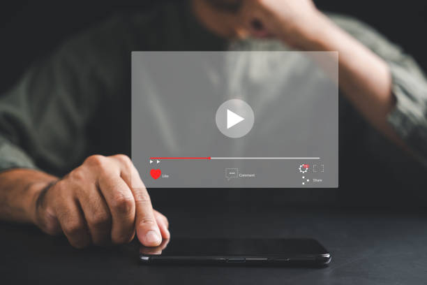 istock Man enjoying video streaming on virtual screen with a smartphone 1807261272