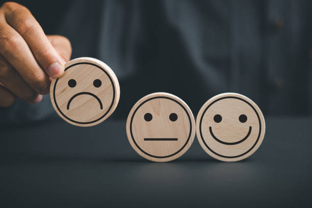 Unsatisfied customer holding frown icon on wooden circle
