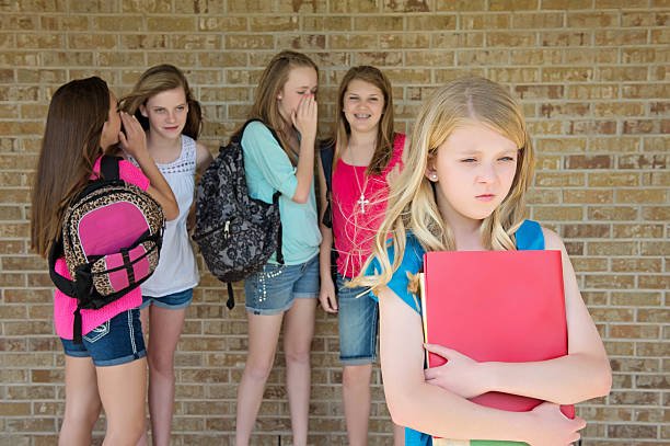 Bullied Preteen Pre-teen girl being bullied by a group of mean girls. school exclusion stock pictures, royalty-free photos & images