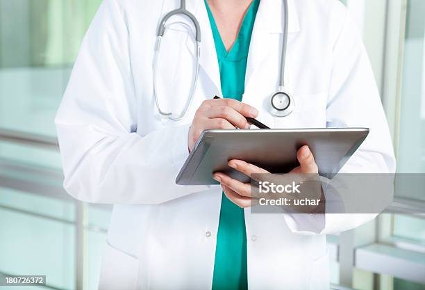 Doctor In The Hospital When Writing Digital Tablets Stock Photo - Download Image Now