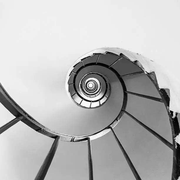 Photo of Spiral staircase, tower interior, directly below, black and white