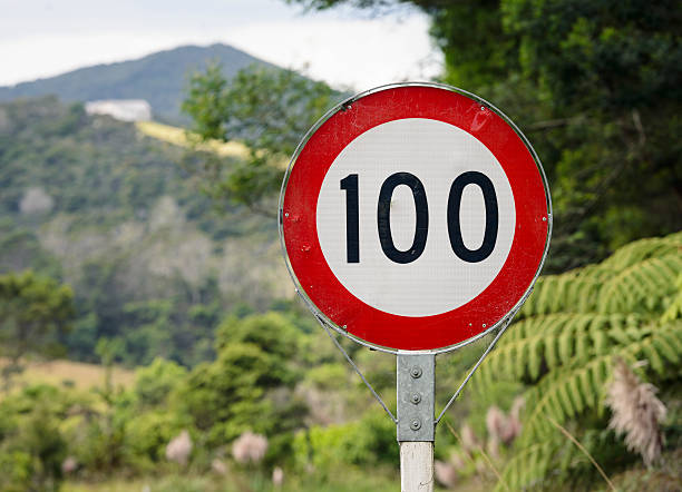 Rural Speed Limit Sign: 100 Kilometres per Hour A 100 Km/hour speed limit sign in rural New Zealand. 100 mph stock pictures, royalty-free photos & images