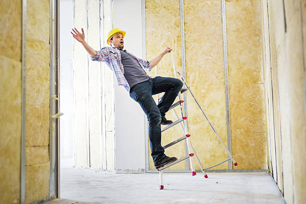 Construction Worker Accident Construction worker has an accident with a ladder. Higher Iso and slightly motion blurred. man hand down stock pictures, royalty-free photos & images