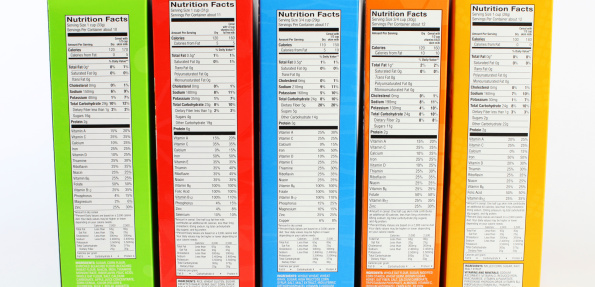 Colorful Cereal Boxes with Nutrition Labels on White Background.
