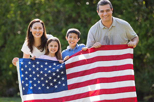 istock Family Holding American Flag At Park 180727111