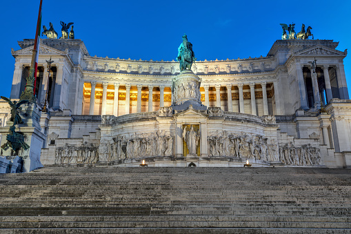 Exterior view of the Victor Emmanuel II National Monument illuminated in the evening in Rome, Italy.