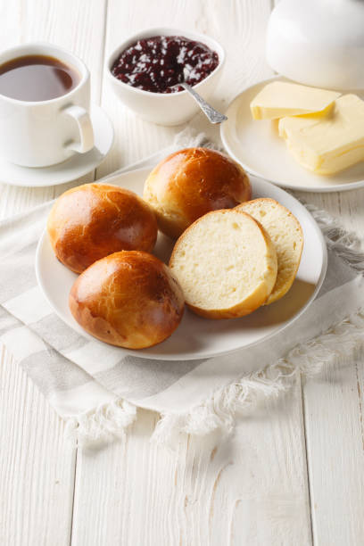 istock Norwegian cardamom rolls served with butter, jam and coffee closeup on thetable. Vertical 1807281115