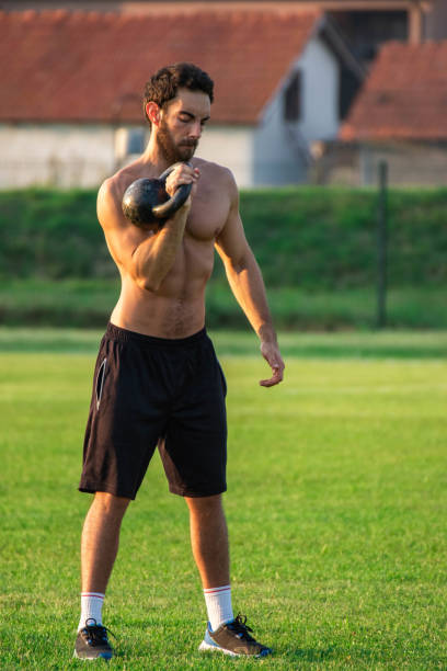 istock Athlete, man on green grass field doing exercise with 1807281666