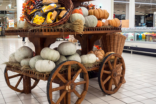 Pumpkins t store pumpkins on a wooden cart. Concept of fall, harvest.