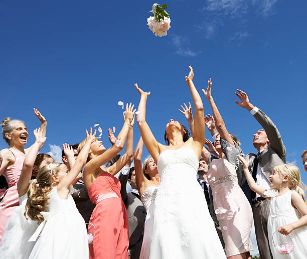 Bride Throwing Bouquet For Guests To Catch stock photo