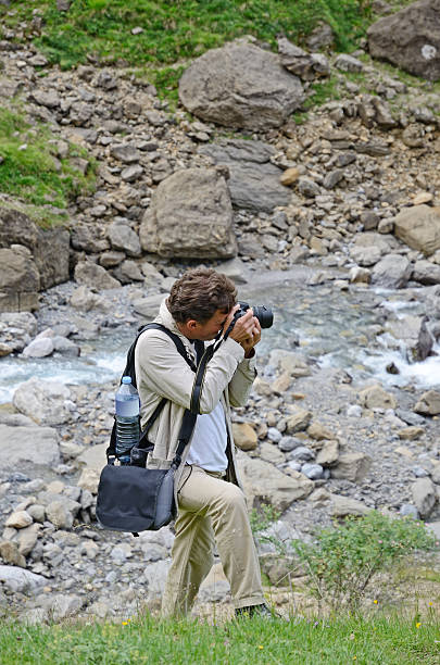 istock Man photographing near the mountain stream 180730603