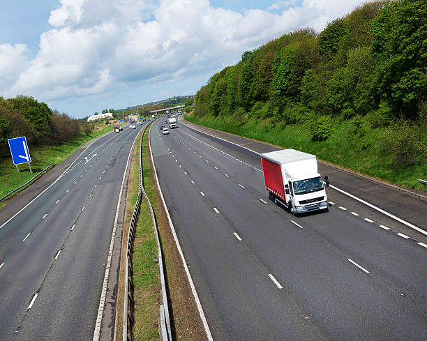 istock Red and White Goods Vehicle on UK Motorway 180730678