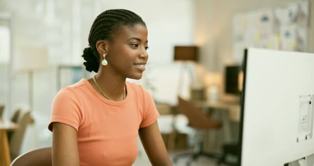 istock Computer, smile and young black woman in the office doing research for creative project. Technology, career and professional African female designer working on desktop in the modern workplace. 1807308702