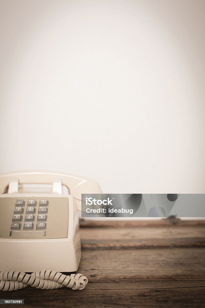 Vintage Push Button Telephone, With Copy Space "Slightly desaturated color image of a vintage, push button telephone sitting on a wood trunk. With room for your text." 1970-1979 Stock Photo