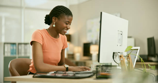 istock Computer, happy and young black woman in the office doing research for creative project. Technology, smile and professional with African female designer working online in the modern workplace 1807314064