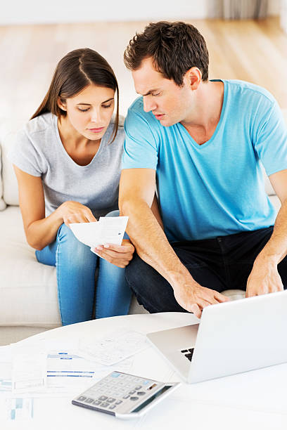 istock Man And Woman Examining Home Expenses 180731535