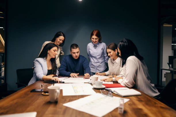 istock Engineers having briefing in a boardroom and discussing blueprints. 1807318963