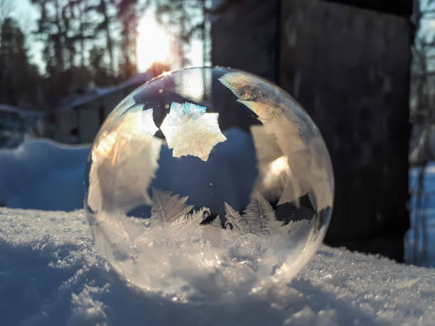 istock Macro of round, frozen soap bubble forming beautiful leaf and tree like pattern while freezing in very cold temperatures in winter 1807322116