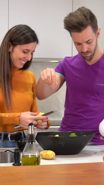 Couple preparing healthy food in a domestic kitchen