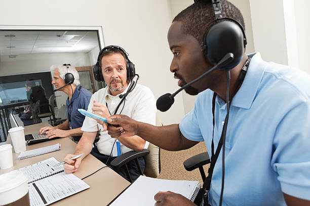 istock Sports Commentators discussing game in the media press box 180732392