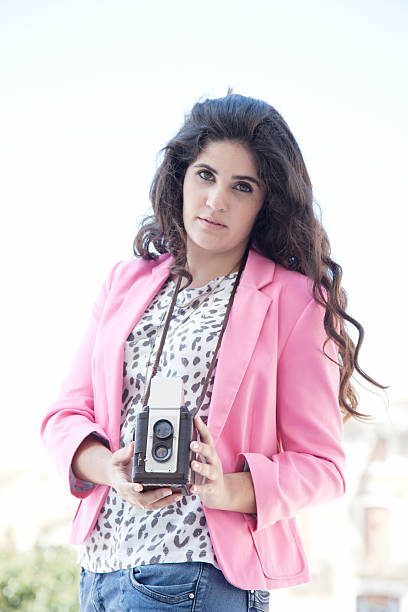 istock Young woman taking picture with vintage camera 180732403