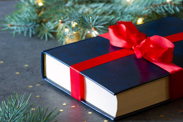 istock Book tied with red ribbon as Christmas gift 1807324822