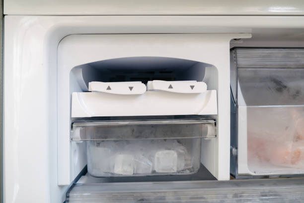 istock Ice maker and tray in the refrigerator 1807325229
