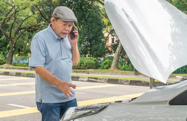 istock Senior driver man with car breakdown and  on phone for roadside assistance 1807326281