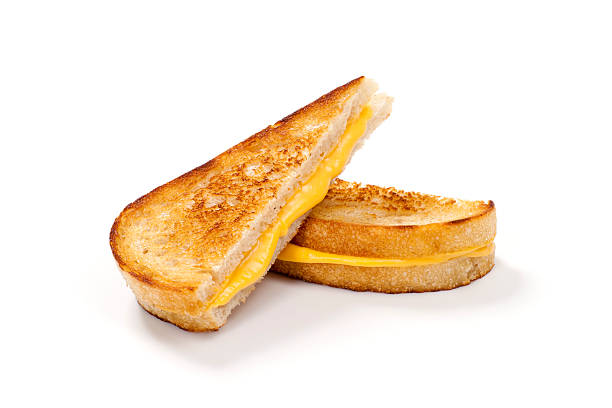 Grilled Cheese Sandwich on Sourdough Bread "Crispy, melty, grilled cheese sandwich on sourdough bread with tomato soup." cheddar cheese photos stock pictures, royalty-free photos & images