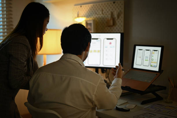 istock Team of creative people brainstorming and discussing for mobile application software design project at night 1807330471
