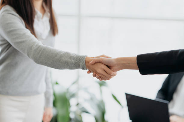 istock Businesswomen shaking hands in office 1807332587
