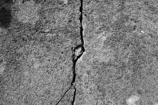 Gray cracked concrete texture background.