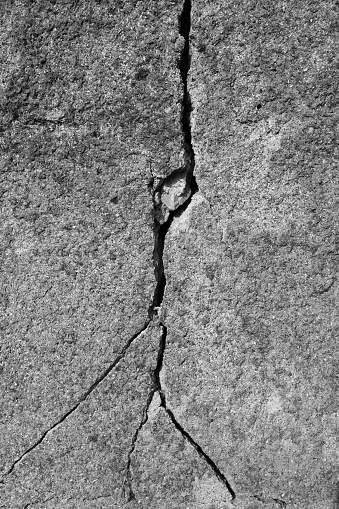 Gray cracked concrete texture background.