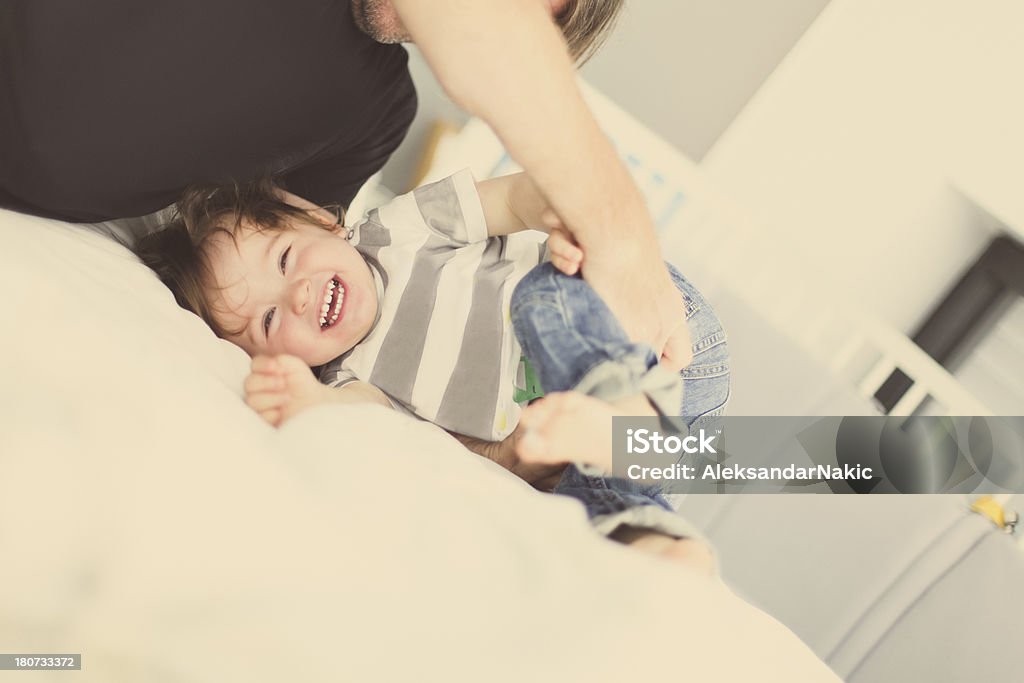 Playtime Father and son laughing and playing Adult Stock Photo