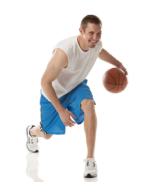 istock Smiling sportsman playing with a basketball 180733443