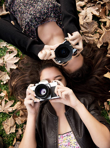 istock Twin sisters taking pictures 180733524