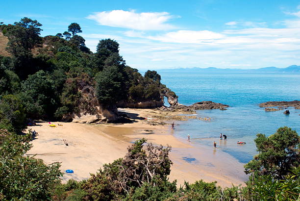 Golden Bay beach with Split Apple Rock geological rock formation in Tasman Bay off the northern coast of the South Island of New Zealand