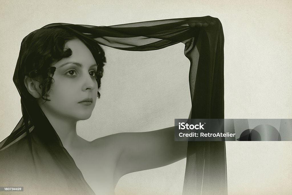 The Sorrow "Emulation of retro-style photography of the 1920s. The photo shows a girl in black cloth. Used classical soft focus for a smooth transition, as well as noise, to enhance retro effect." One Woman Only Stock Photo
