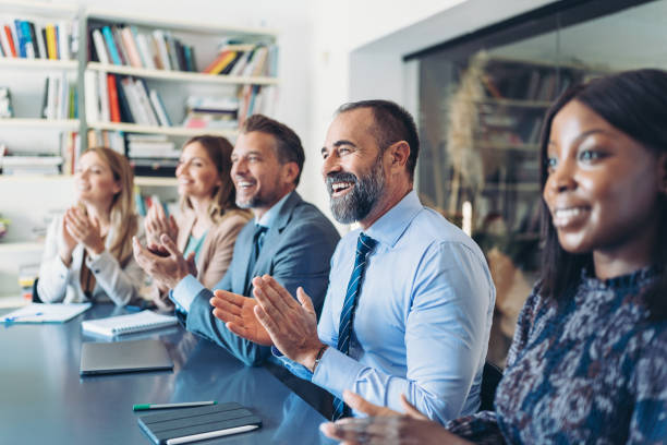 istock Focus on a mature businessman applauding during a conference 1807347935