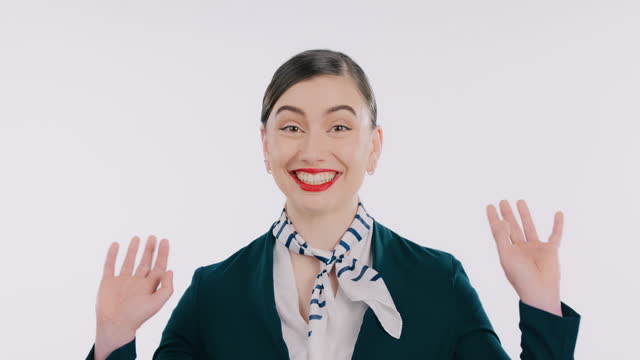 Flight attendant, smile and woman in presentation, portrait and communication by white background. Female person, hello and emoji or hand sign in studio, confidence and pride on face, welcome or wave