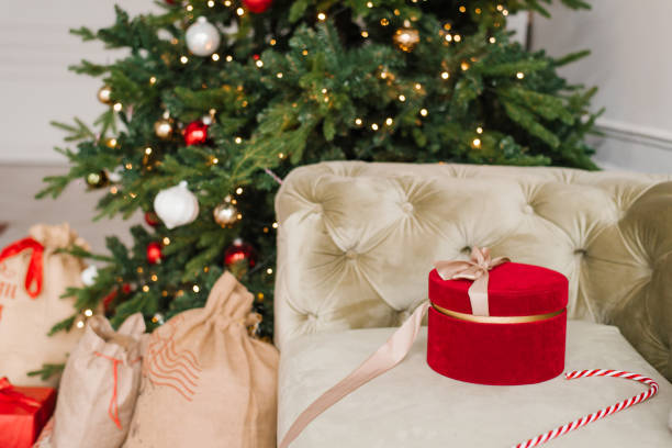 istock Red gift box on the background of a Christmas tree 1807353333