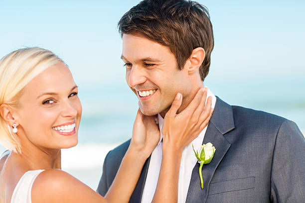 istock Loving Bride With Groom Looking At Her On Beach 180735725